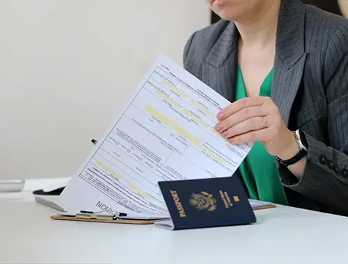 Applicant reviewing documents to prove temporary intent and ties outside Canada for a visa application.